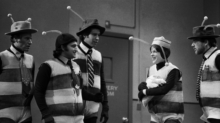 Black-and-white NBC image of Gilda Radner, Chevy Chase, John Belushi and co in the infamous SNL Bee suits from Season 1, 1975.