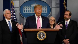 President Trump talks at a news briefing alongside HHS Secretary Alex Azar (right) and the CDC’s Principal Deputy Director Dr. Anne Schuchat (2-R).