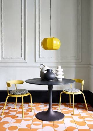 dining area with a colour block floor in pink and orange