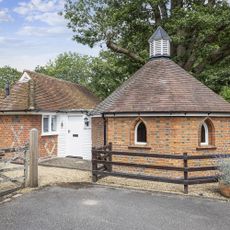 octagonal shaped dairy exterior with brick wall and white door