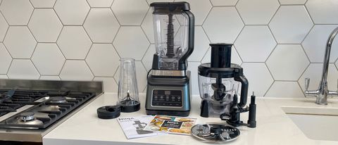 The Ninja 3-in-1 Food Processor with Auto-IQ BN800UK with all its accessories on a kitchen countertop