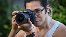 Man taking photo with Nikon D500