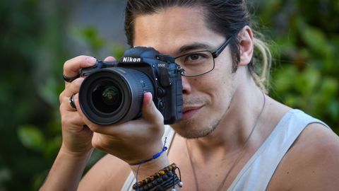 Man taking photo with Nikon D500