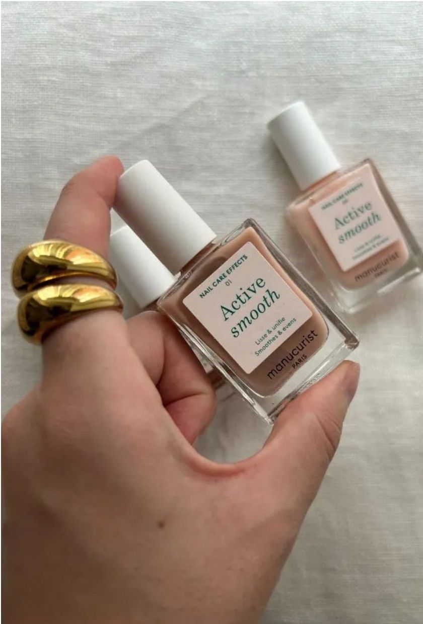 Grace Lindsay holding a bottle of Manucurist Active Smooth nail polish