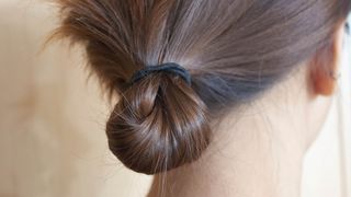 Someone's hair tied back using a hair tie
