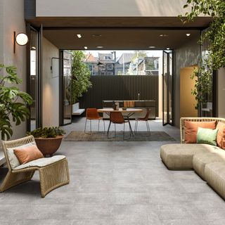 patio area with sofa and potted plants