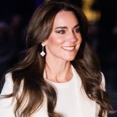 Kate Middleton in 2023 wearing a white coat and a white top styled by Natasha Archer