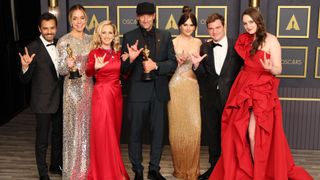 The cast of Apple TV Plus film CODA pose with their Academy Awards at the 2022 Oscars ceremony