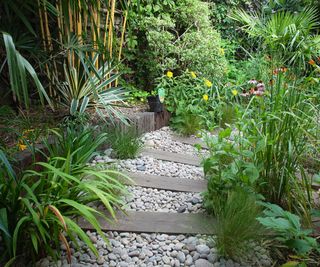 pebble path with railway sleepers in small garden