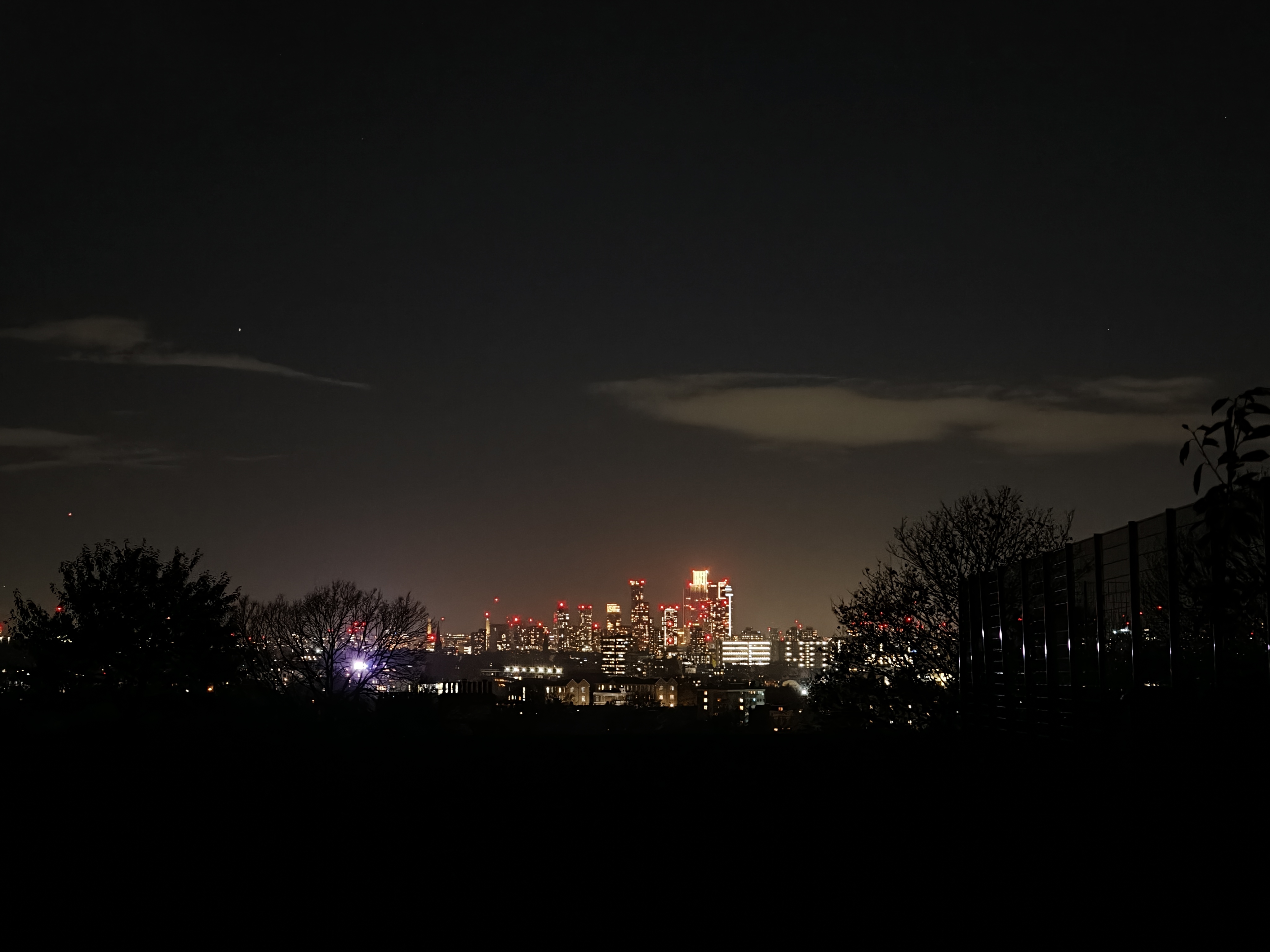 A view of London from a dark park