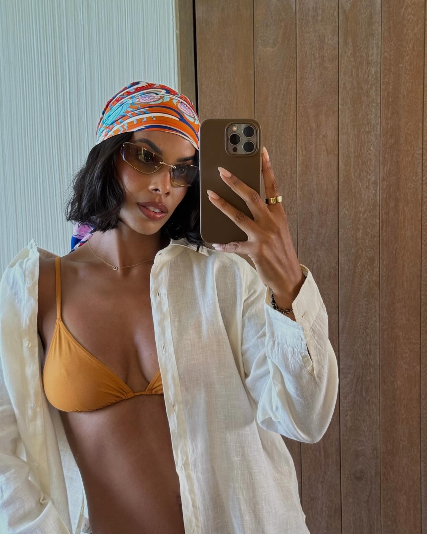 Rochelle Humes taking a selfie on holiday with a bob hairstyle and a silk scarf