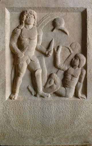 This 1,800-year-old tombstone depicts a gladiator holding two swords standing above his defeated opponent who is signalling submission. The inscription below says Diodoros, a gladiator, was buried here.