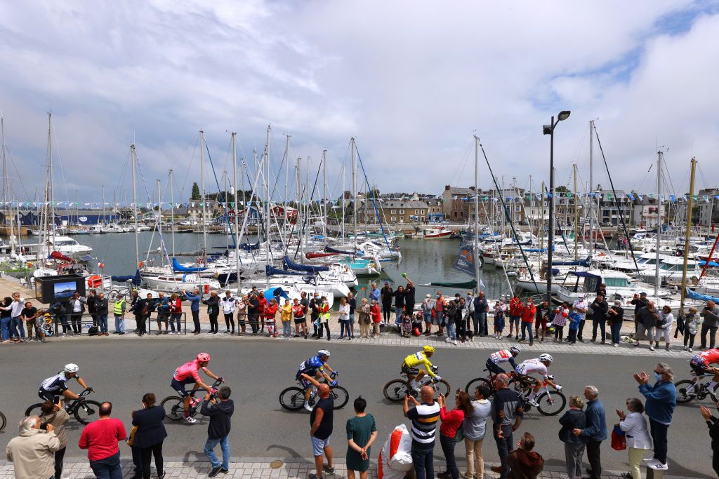MRDEBRETAGNE GUERLDAN FRANCE JUNE 27 Jonas Rutsch of Germany and Team EF Education Nippo Julian Alaphilippe of France and Team Deceuninck QuickStep Yellow Leader Jersey Julien Bernard of France and Team Trek Segafredo Aurlien ParetPeintre of France and AG2R Citron Team The Peloton passing through Paimpol Village during the 108th Tour de France 2021 Stage 2 a 1835km stage from PerrosGuirec to MrdeBretagne Guerldan 293m Fans Public Landscape Sea Boats LeTour TDF2021 on June 27 2021 in MrdeBretagne Guerldan France Photo by Tim de WaeleGetty Images