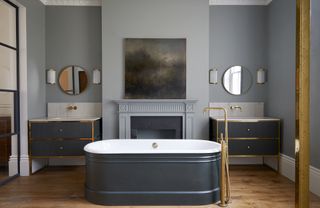 Luxurious master bathroom by Drummonds painted in gray