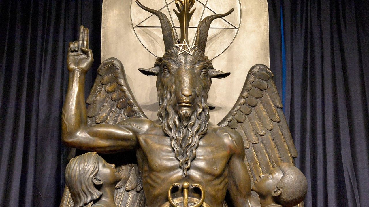 Baphomet, the goat deity, sits in a regal position while two children look on