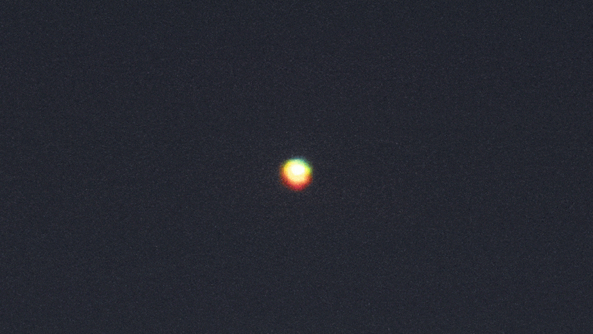 Looped video footage of a green flash coming from Venus in the night sky