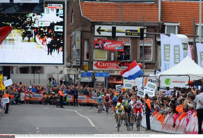 In the background Dan Martin's front wheel can just be seen as Simon Gerrans jumps away for the win