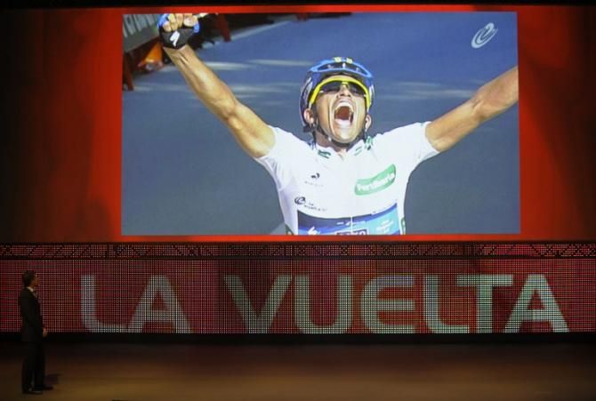 Former Spanish cyclist Perico Delgado (L) watches a video as he attends the presentation of the 68th Vuelta