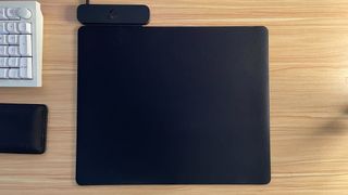 The Logitech PowerPlay 2 mouse pad on a desk.