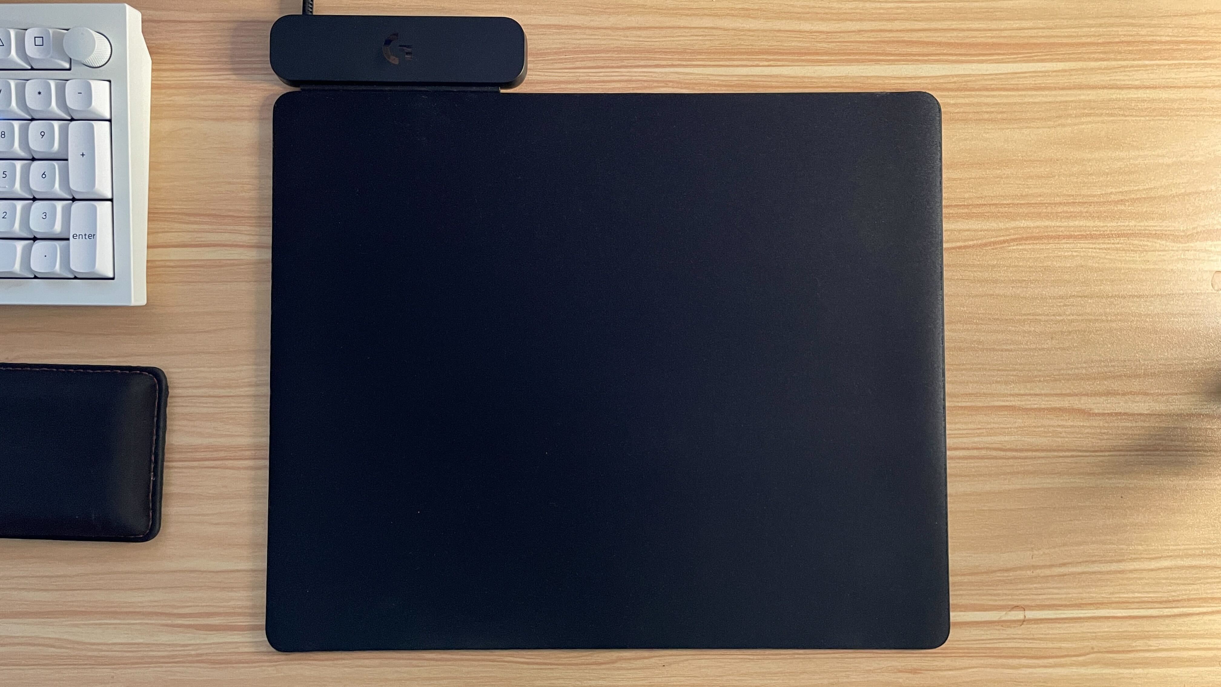 The Logitech PowerPlay 2 mouse pad on a desk.