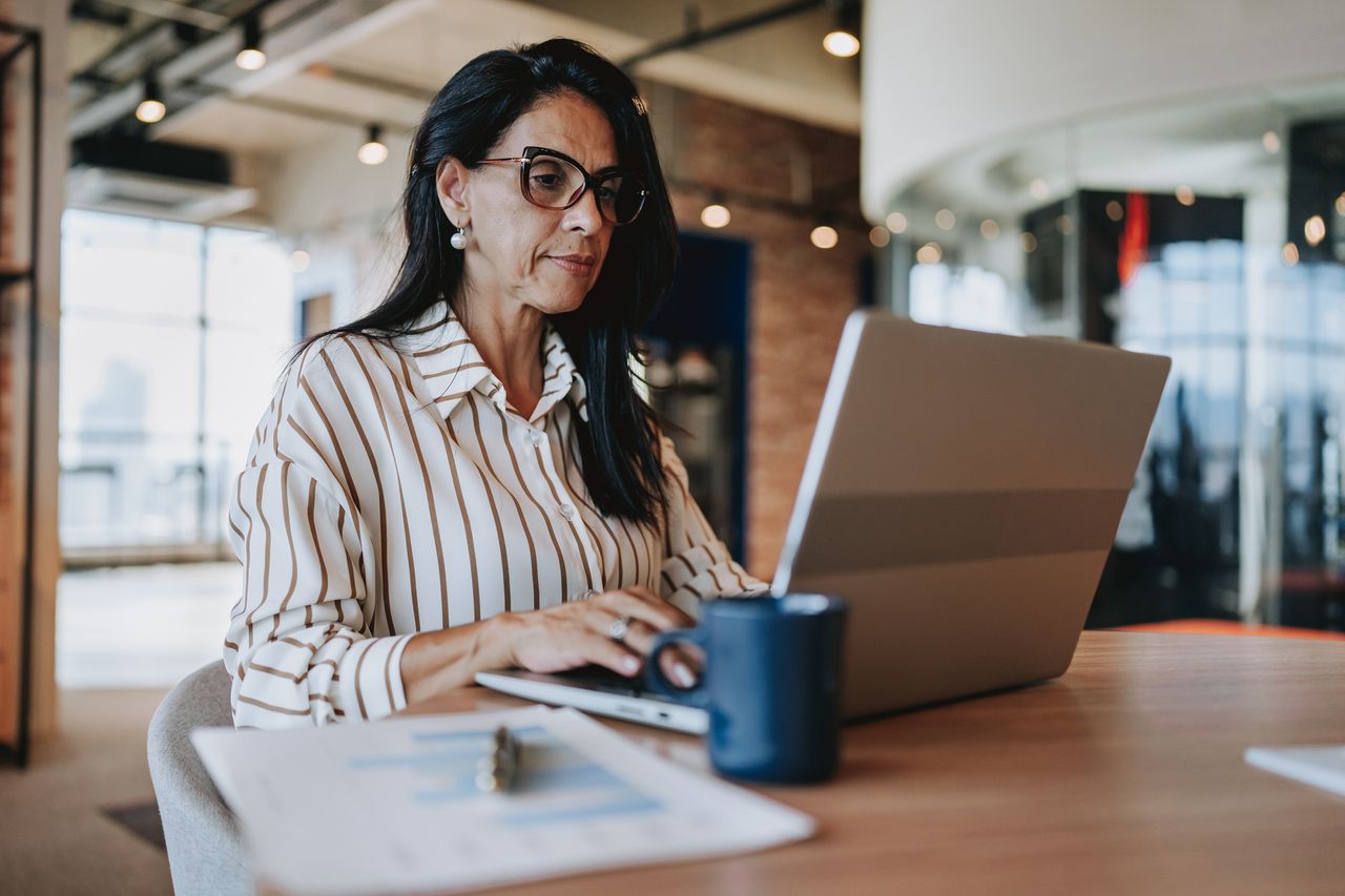 Portrait of businesswoman working on laptop 