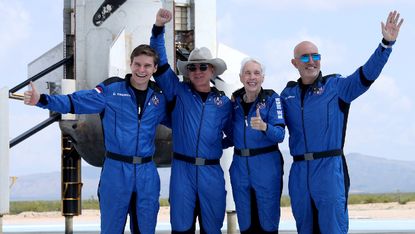 Jeff Bezos (second left) and his Blue Origin crew after flying into space