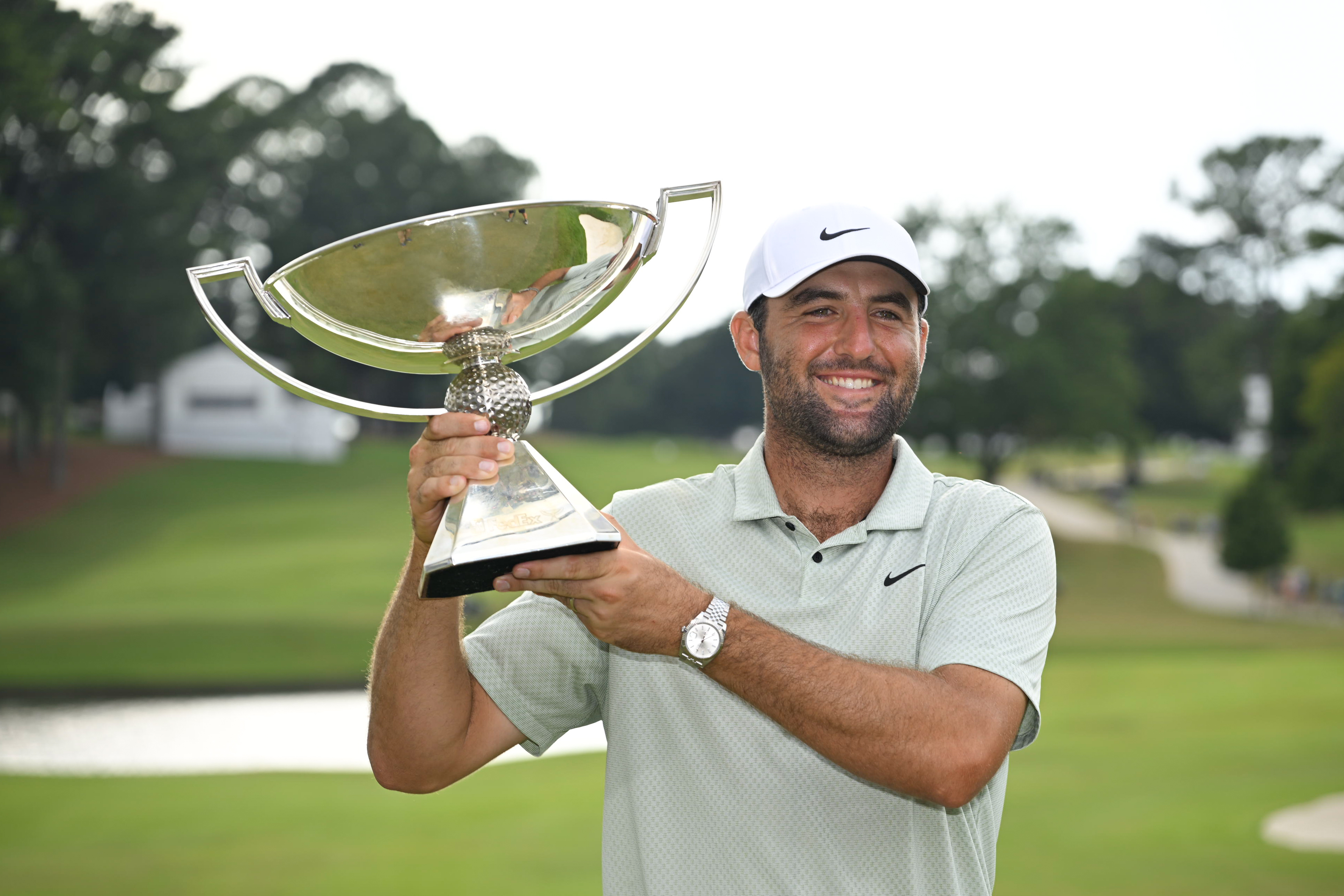 Scottie Scheffler holds the FedEx Cup trophy