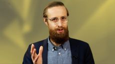 Presenter Ant Joblin on a yellow background talking to the camera