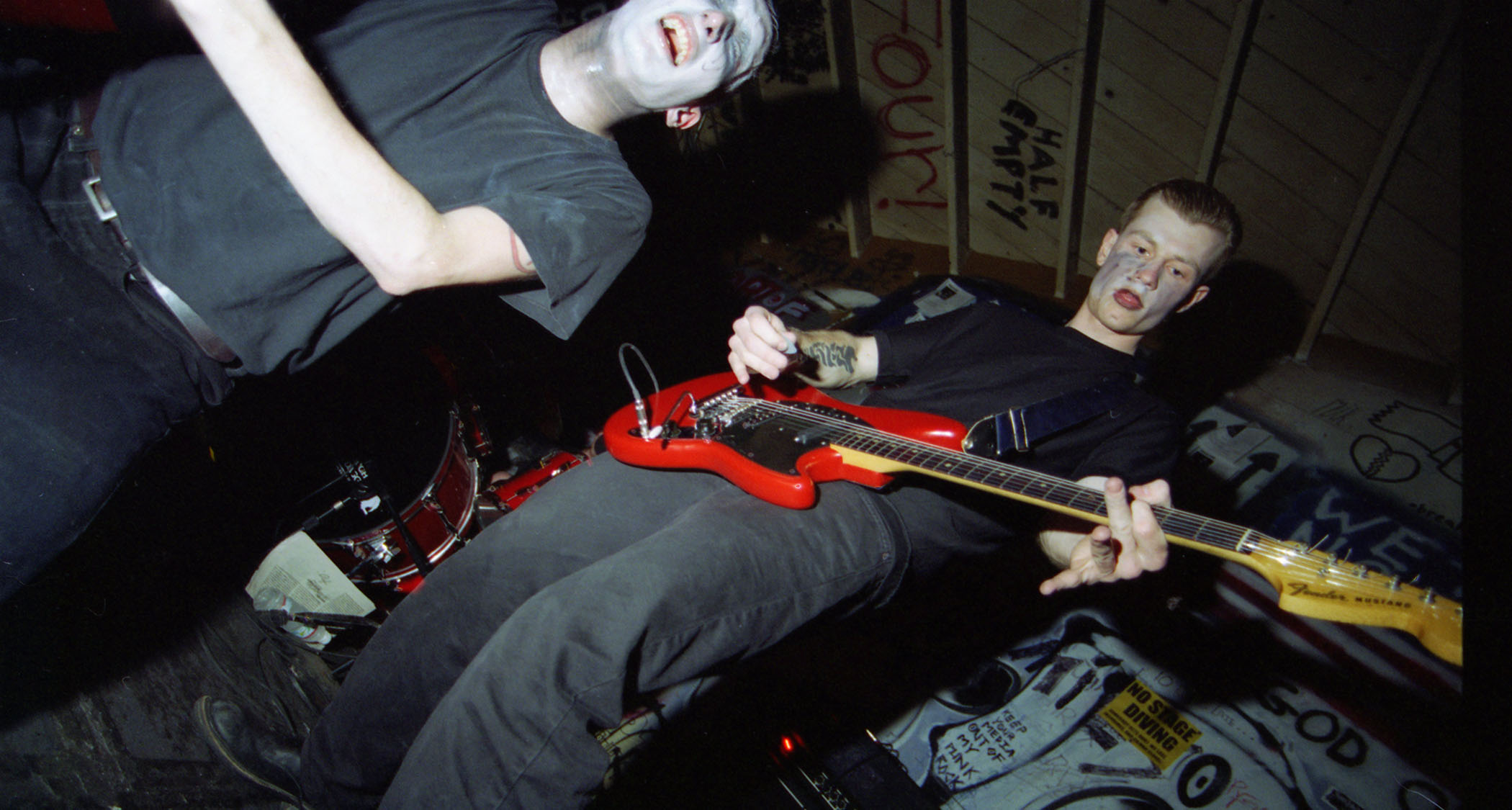 Ink &amp;amp; Dagger perform in makeup in a suitably punk looking venue with spray-painted walls.