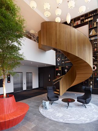 Wooden spiral staircase with tree/bench as feature piece