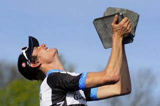 Johan Vansummeren finds the strength to hold aloft the trophy