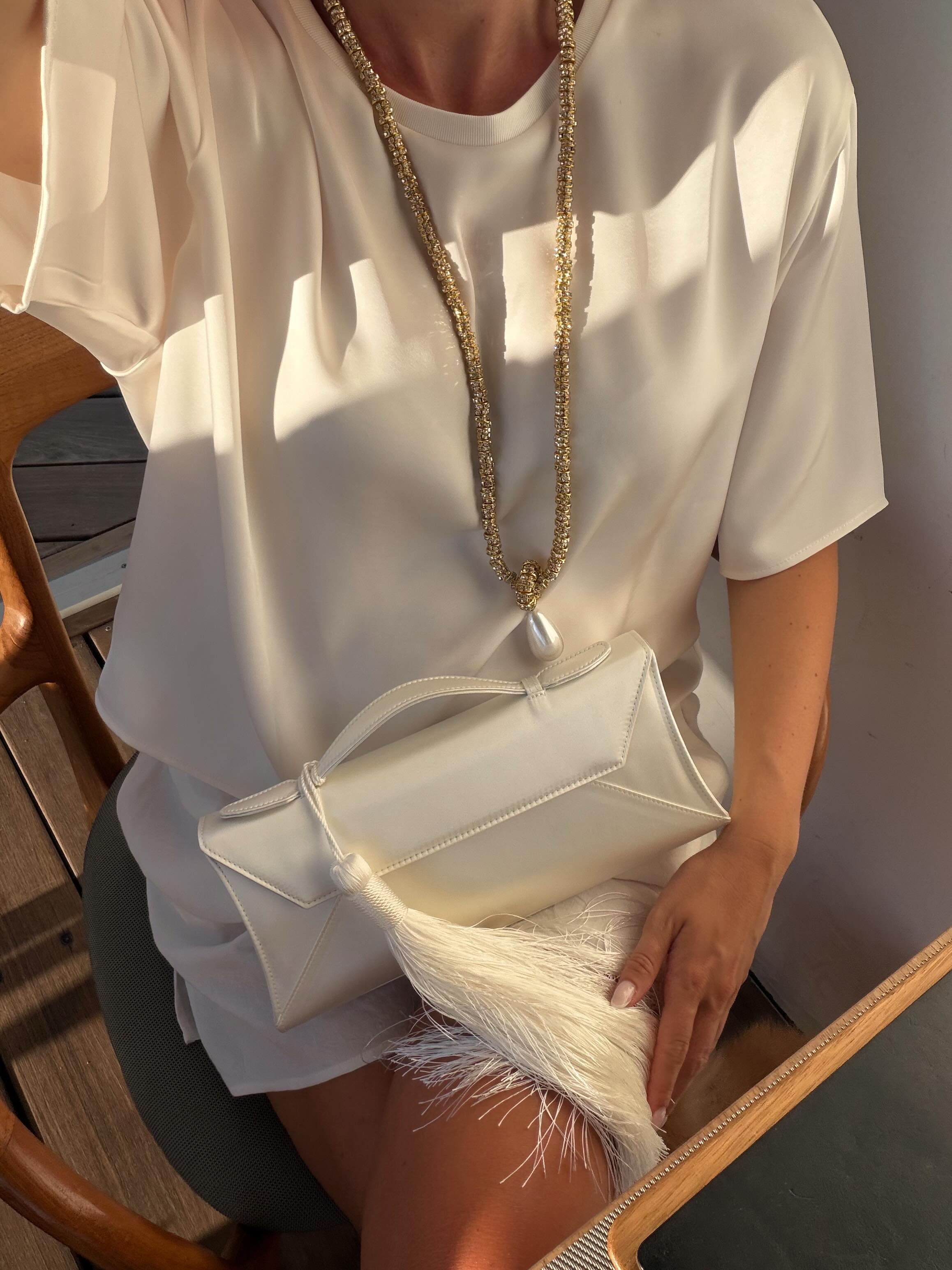 Lovisa holding a tasselled clutch