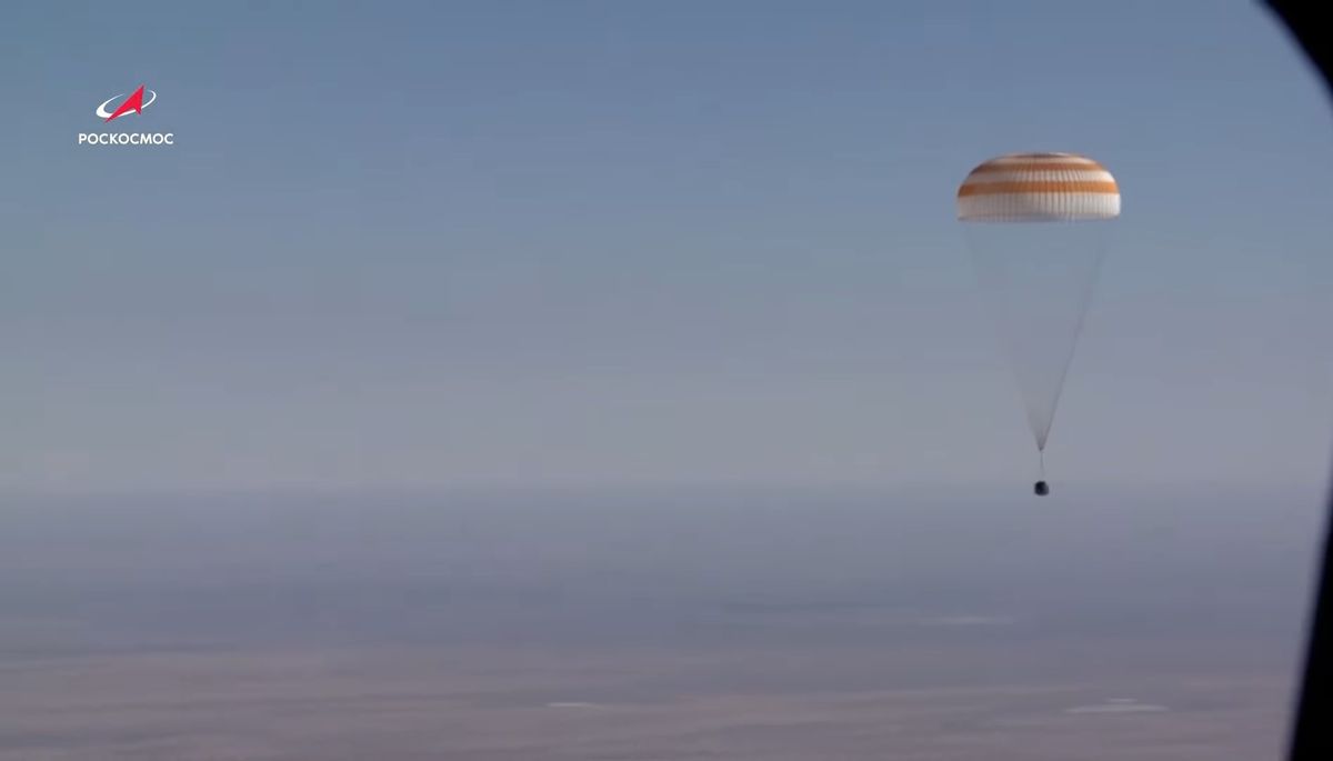 A Soyuz MS-18 space capsule carrying Russian actress Yulia Peresild, director Klim Shipenko and cosmonaut Oleg Novitskiy returns to Earth under a parachute during a successful landing in Kazakhstan on Oct. 17, 2021.