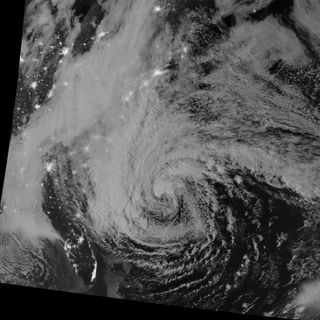 This night-view image of Hurricane Sandy was acquired by the Visible Infrared Imaging Radiometer Suite (VIIRS) on the Suomi NPP satellite around 2:42 a.m. Eastern Daylight Time (06:42 Universal Time) on October 28, 2012. In this case, the cloud tops were lit by the nearly full Moon (full occurs on October 29). Some city lights in Florida and Georgia are also visible amid the clouds.