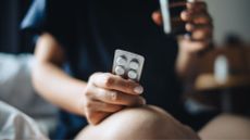 Woman holding Veoza packet of tablets