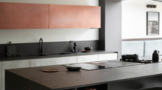 modern kitchen with black porcelain counters and red overhead cabinets