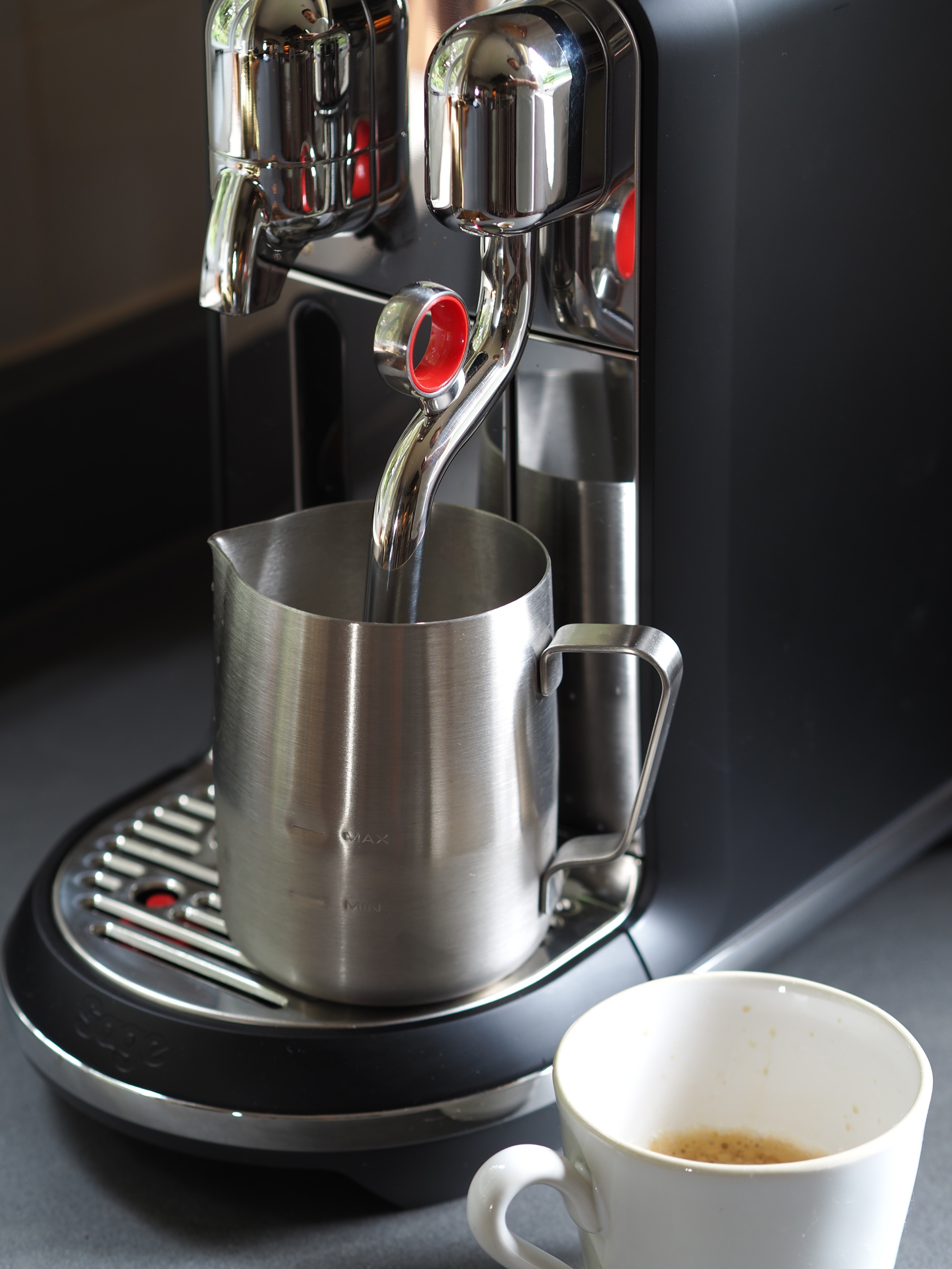 Close up of nespresso creatista plus by sage, being used to make a coffee