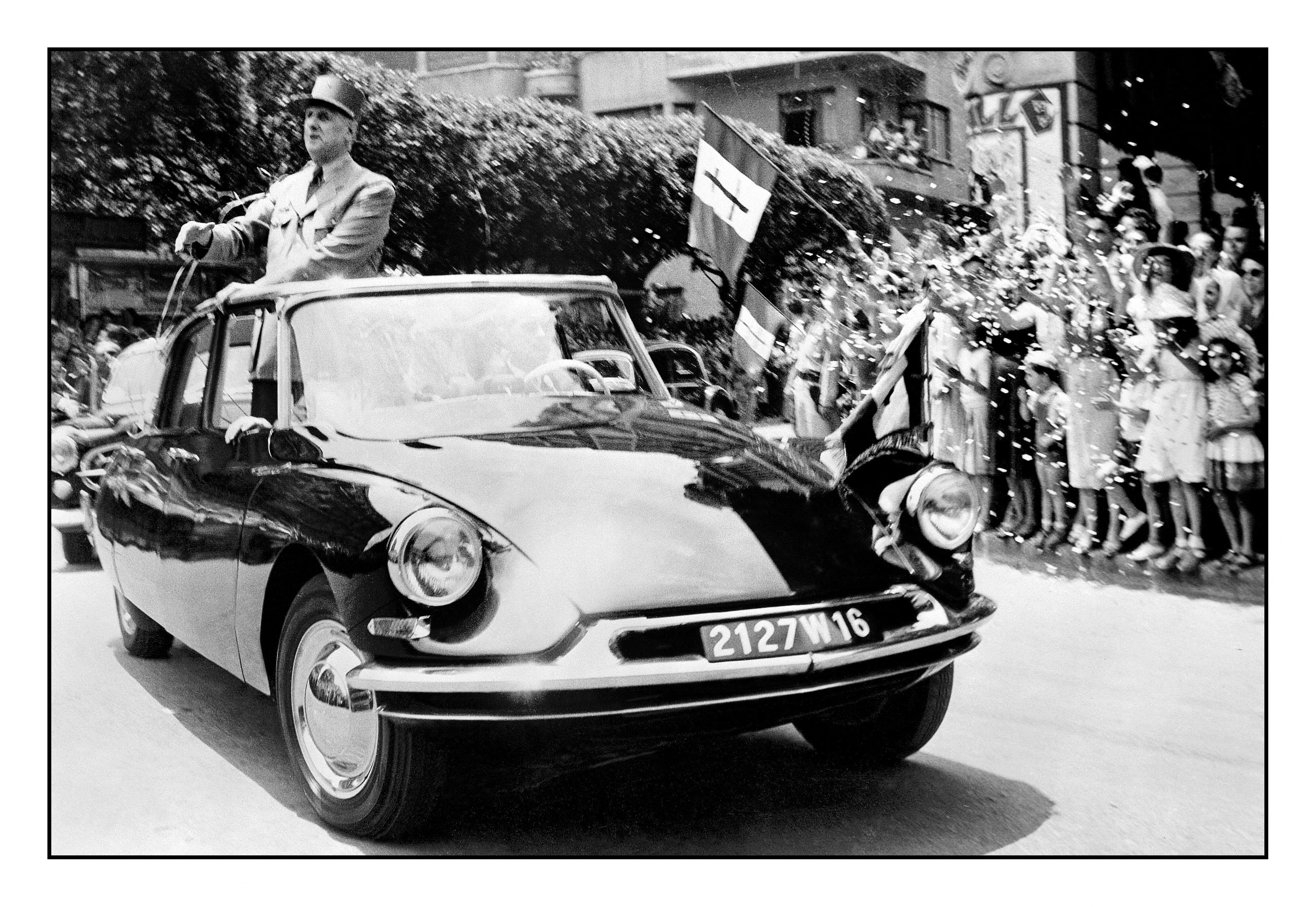 President Charles De Gaulle post war popular hero of France in a Citroen DS 19. The aerodynamic Citroen DS 19, was also known as La Deesse (The Goddess).