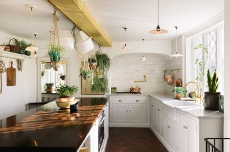 A white classic kitchen from deVOL with marble and wooden worktops