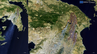 A satellite view of Athens with wildfires burning in a hefty chunk of land.