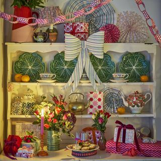 festive dresser shelving filled with red and white decor