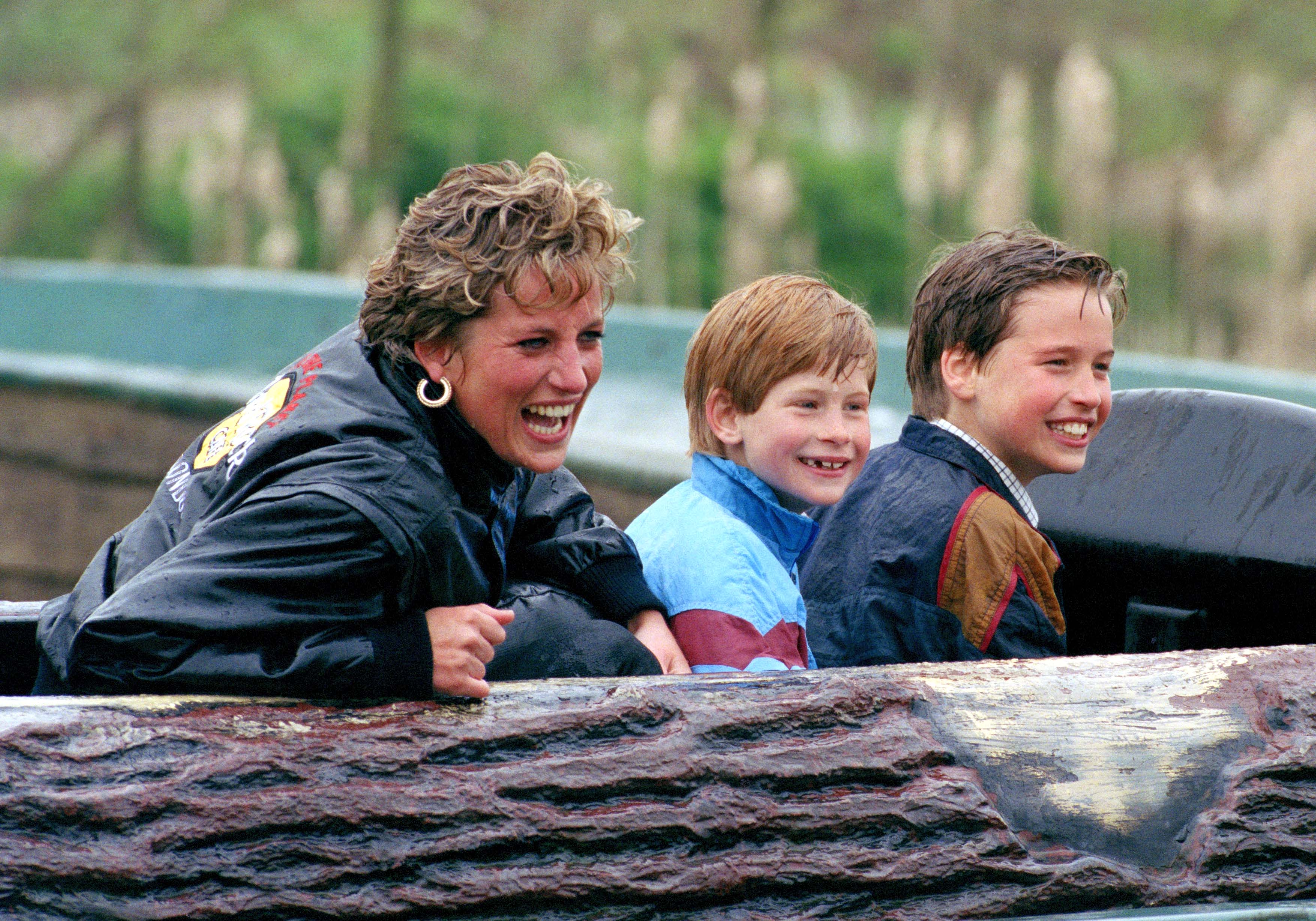 Princess Diana, Prince Harry and Prince William laughing in a log flume