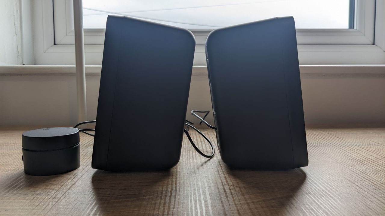 The Trust GXT 611 Wezz RGB speakers pictured on a wooden desk.