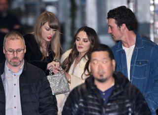 Taylor Swift shows off an allegedly new ring to friends Keleigh Teller and Miles Teller.