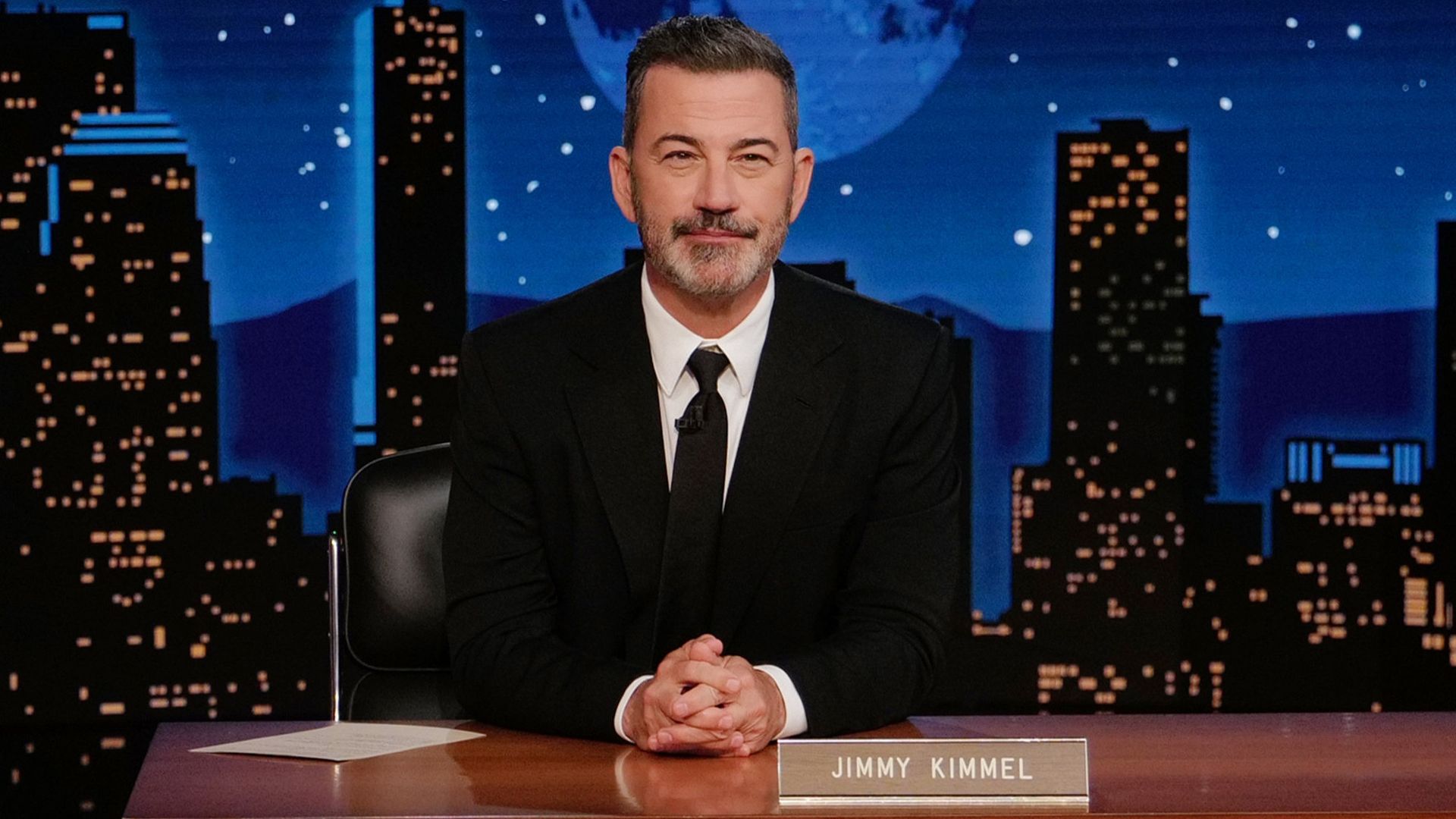 Jimmy Kimmel sits at his desk on Jimmy Kimmel Live!
