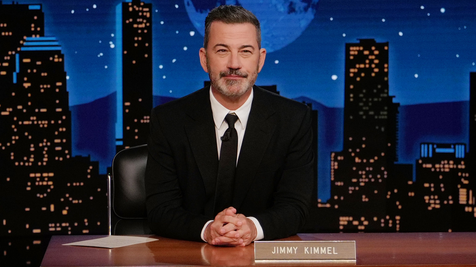 Jimmy Kimmel sits at his desk on Jimmy Kimmel Live!