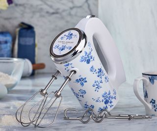 A Laura Ashley & VQ hand mixer on a marble surface