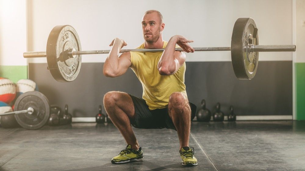 Man performs barbell front squat