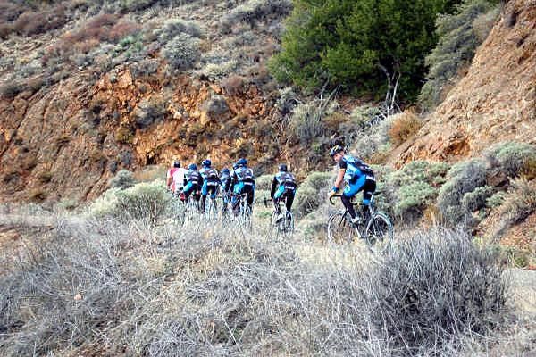Lance looks back after getting caught by the group, they are almost at the top where Lance calls it a day.