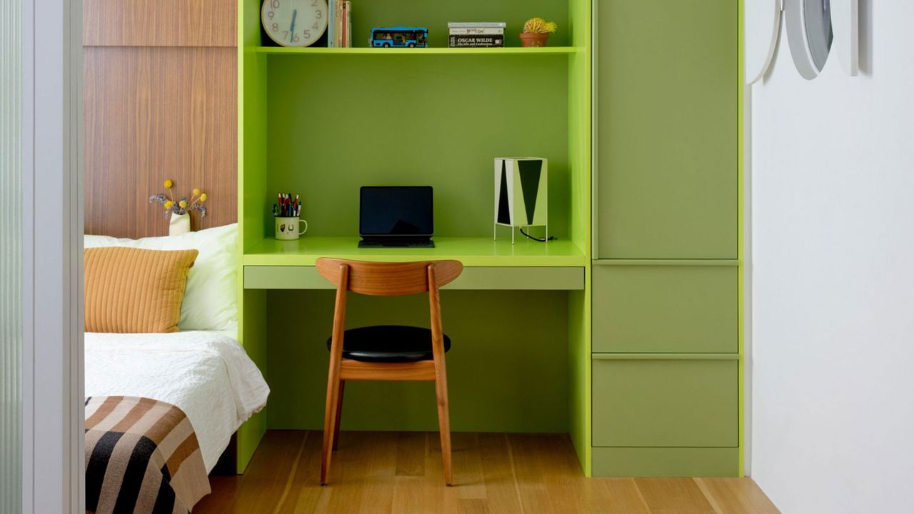 a lime green built in desk in a bedroom in a new york apartment